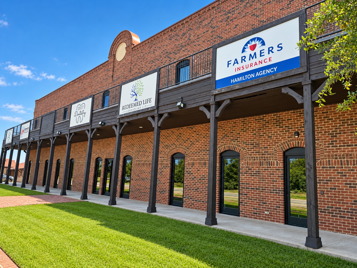 Commercial glass entrances along the brick office frontage