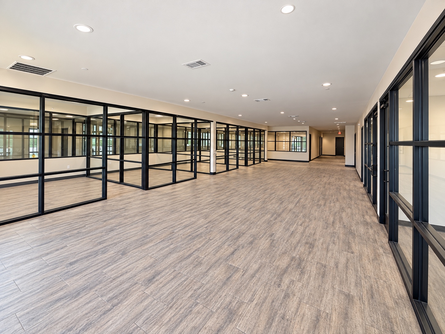Separate interior office project with black framed glass partitions and doors