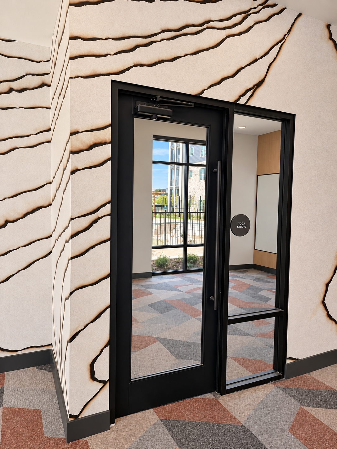 Glass studio door and sidelight at the featured multifamily project